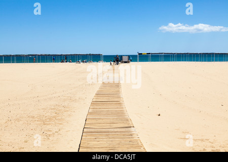 Slatted wood wheelchair access ramp to beach at Cambrils. Stock Photo