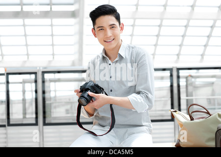 Young man with SLR camera at subway station Stock Photo - Alamy