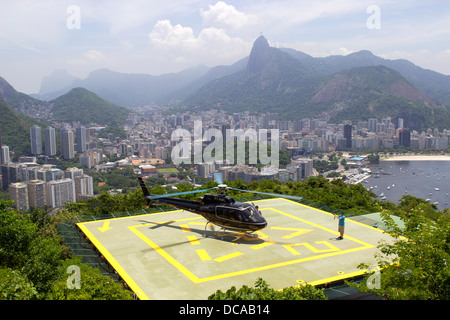 Tourists about to depart on a helicopter from the Sugar Loaf to take a tour of Rio de Janeiro, Brazil, February 2013. Stock Photo