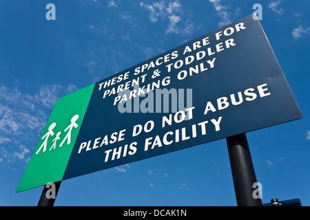A sign in a Morrison's supermarket car park indicating parent and toddler parking only. Stock Photo