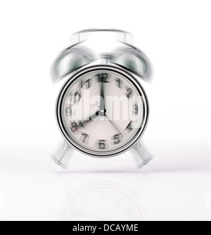 Classic Alarm clock chromed ringing, with movement effect. Front view on white background, with slight reflection on the surface Stock Photo