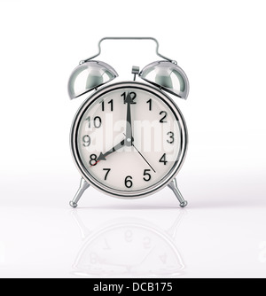 Classic Alarm clock chromed, front view on white background, with slight reflection on the surface. Hands at 8 o' clock. Stock Photo