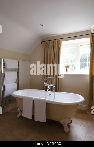 Free standing claw-foot bath in front of window, Barnsley, UK. Stock Photo
