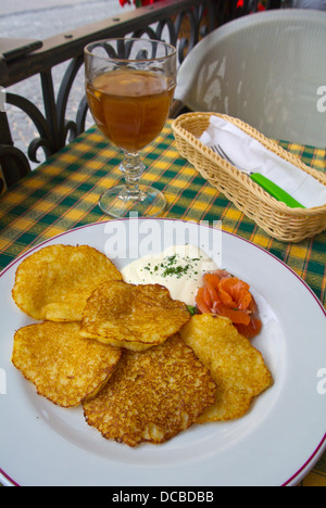 Local cuisine savory pancakes with salmon and kvass beverage in restaurant Vilnius Lithuania Europe Stock Photo