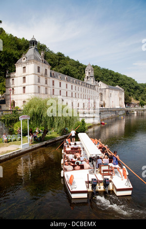 A tourist boat tour on the River Dronne moors at the 7th century Benedictine Abbey, Brantome, the Dordogne, France Europe Stock Photo