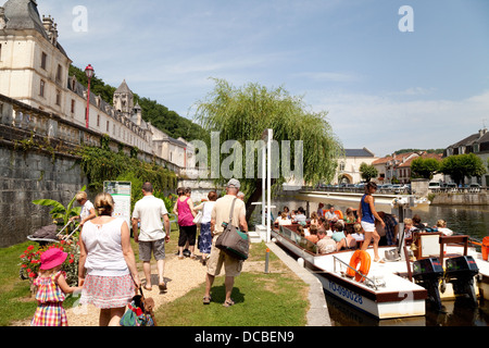 Tourists embarking on a guided boat trip on the river Dronne by the Benedictine Abbey, at Brantome, the Dordogne, France Europe Stock Photo