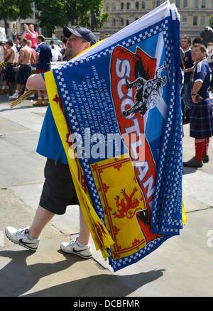 London, UK. 14th Aug, 2013. Scotland fans gather in Trafalgar Square ahead of their friendly match against England. A monster game of football around Trafalgar Square with Scottish fans taking over most of the area during the afternoon, before the England game. Credit:  Dorset Media Service/Alamy Live News Stock Photo