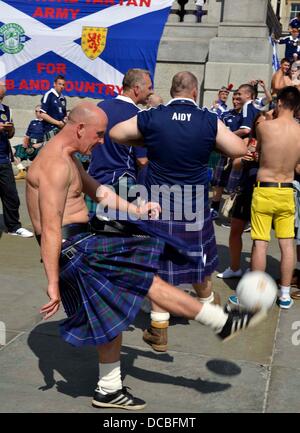 London, UK. 14th Aug, 2013. Scotland fans gather in Trafalgar Square ahead of their friendly match against England. A monster game of football around Trafalgar Square with Scottish fans taking over most of the area during the afternoon, before the England game. Credit:  Dorset Media Service/Alamy Live News Stock Photo