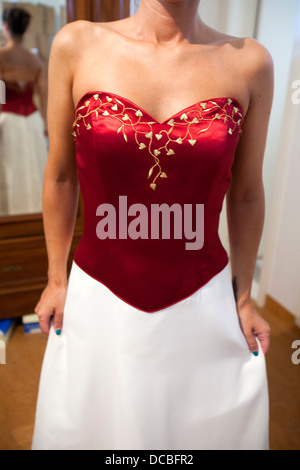 Young woman trying on wedding dress. Stock Photo