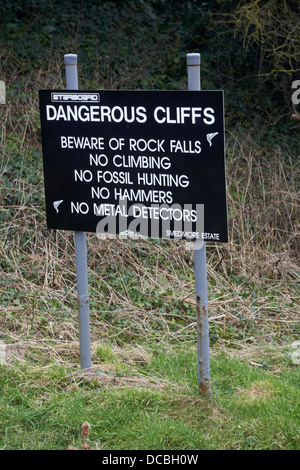 Dangerous cliffs beware of rock falls no climbing no fossil hunting no hammers no metal detectors sign by Smedmore Estate Stock Photo