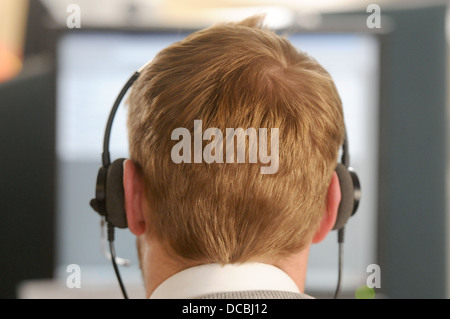 A call centre worker busy on the telephone Stock Photo