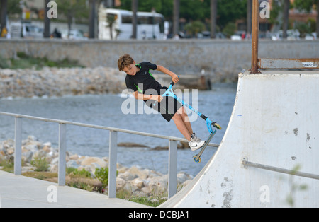 Boy performs stunts with a scooter, Ajaccio, Corsica, France Stock Photo