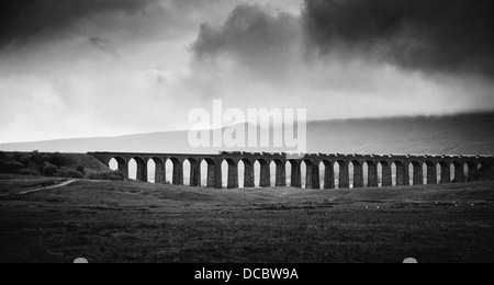 A train crossing Ribblehead viaduct, Ingleborough National Nature Reserve, Yorkshire Dales Stock Photo