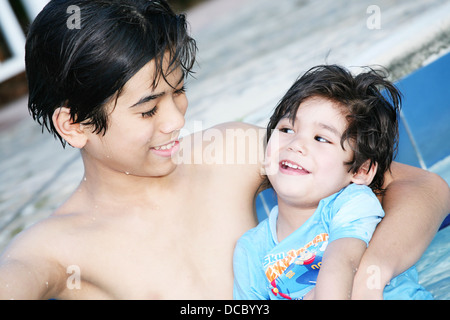 Big brother taking care of baby brother Stock Photo