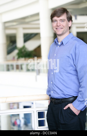 Handsome businessman leaning on railing Stock Photo