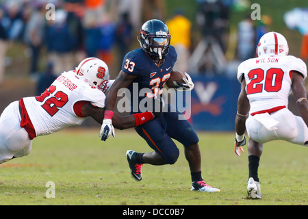 Virginia Cavaliers running back Perry Jones (33) breaks a tackle from North Carolina State Wolfpack defensive end Darryl Cato-Bi Stock Photo