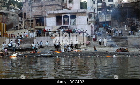 People gather at one of the burning ghats on the banks of the RIver Ganges in Varanasi, India Stock Photo