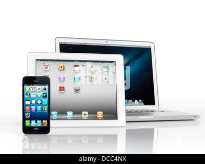 Electronics still life of three Apple devices, iPhone, iPad and Macbook Pro, smartphone, tablet and laptop computer, isolated Stock Photo