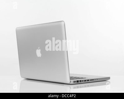 Macbook Pro laptop computer rear view with Apple logo on the lid isolated on white background Stock Photo