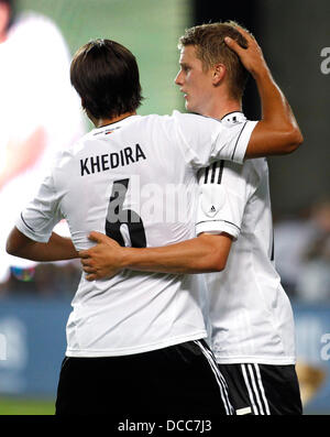 Kaiserslautern, Germany. 14th Aug, 2013. Germany's Lars Bender (R) celebrates scoring the 3:3 with Sami Khedira during the soccer match between Germany and Paraguay, Fritz Walter stadium in Kaiserslautern on August 14, 2013. © dpa picture alliance/Alamy Live News Stock Photo