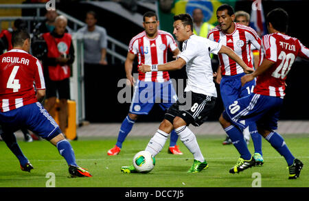 Kaiserslautern, Germany. 14th Aug, 2013. Germany's Mesut Özil (M) against four players of paraguay during the soccer match between Germany and Paraguay, Fritz Walter stadium in Kaiserslautern on August 14, 2013. © dpa picture alliance/Alamy Live News Stock Photo