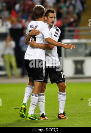 Kaiserslautern, Germany. 14th Aug, 2013. Germany's Thomas Müller (L) celebrates scoring the 2:2 with Miroslav Klose during the soccer match between Germany and Paraguay, Fritz Walter stadium in Kaiserslautern on August 14, 2013. © dpa picture alliance/Alamy Live News Stock Photo