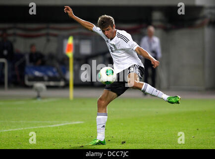 Kaiserslautern, Germany. 14th Aug, 2013. Germany's Thomas Müller shot the 2:2 during the soccer match between Germany and Paraguay, Fritz Walter stadium in Kaiserslautern on August 14, 2013. © dpa picture alliance/Alamy Live News Stock Photo