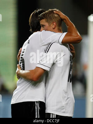 Kaiserslautern, Germany. 14th Aug, 2013. Germany's Lars Bender (R) celebrates scoring the 3:3 with Sami Khedira during the soccer match between Germany and Paraguay, Fritz Walter stadium in Kaiserslautern on August 14, 2013. © dpa picture alliance/Alamy Live News Stock Photo