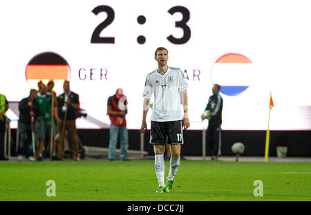 Kaiserslautern, Germany. 14th Aug, 2013. Germany's Per Mertesacker disappointed after the 2:3 during the soccer match between Germany and Paraguay, Fritz Walter stadium in Kaiserslautern on August 14, 2013. © dpa picture alliance/Alamy Live News Stock Photo