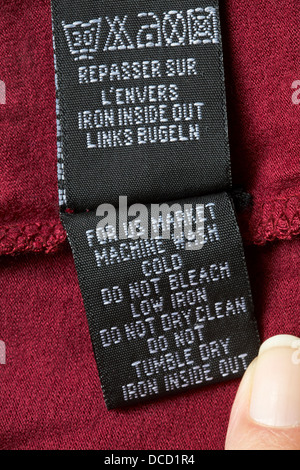 label in garment - For US market machine wash cold do not bleach low iron do not dry clean do not tumble dry iron inside out - care washing symbols Stock Photo