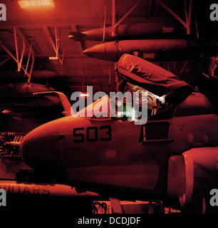 An EA-6B Prowler intelligence-gathering patrol aircraft is worked on in the hangar deck of the US Navy's Harry S Truman aircraft carrier whilst on exercise somewhere in the Persian Gulf. Stock Photo