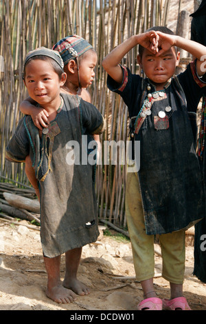 Ethnic Akha children  wearing traditional clothes in tribal village near Phongsali, Laos Stock Photo