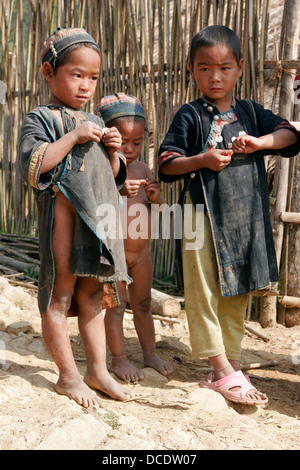 Ethnic Akha children wearing traditional clothes in tribal village near Phongsali, Laos Stock Photo