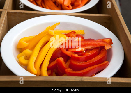 Peppers slices in red and yellow colors on plate in box Stock Photo