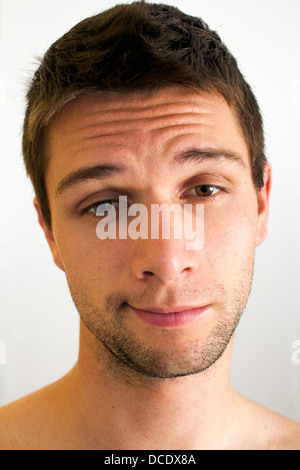 Extremely tired man with half open eyes Stock Photo