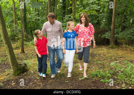 family walking through woodland / forest Stock Photo
