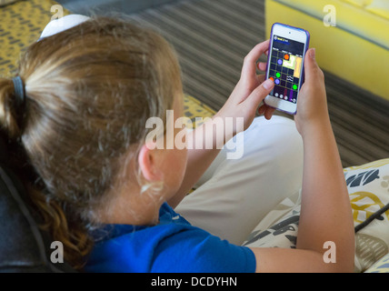 young girl playing game on her smartphone Stock Photo