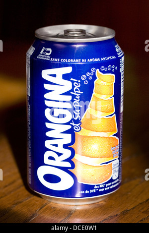Orangina can on a wooden table. Stock Photo