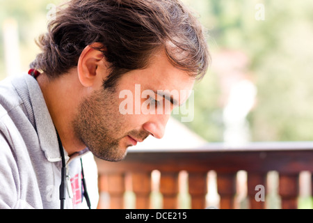 Young man looking down in outdoor Stock Photo