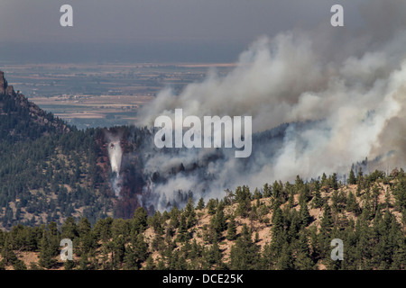 USA, Colorado, Boulder, Flagstaff Fire, Helicopter Dropping Water on Forest Fire. Stock Photo