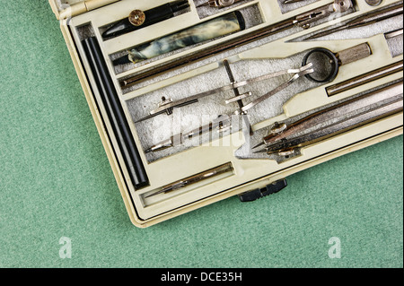 Old drawing tools in a box on a green background Stock Photo