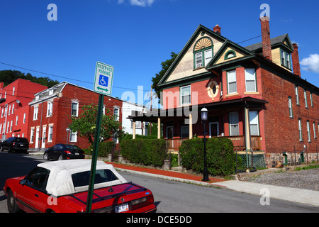 Reserved disabled parking space sign and typical brick house in suburbs, Cumberland , Allegany County , Maryland , USA Stock Photo