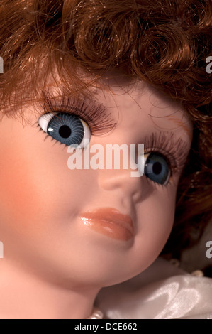 Face of pretty doll with blue eye and red hair Stock Photo