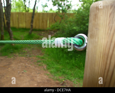 Tensioned rope barrier on wooden post Stock Photo