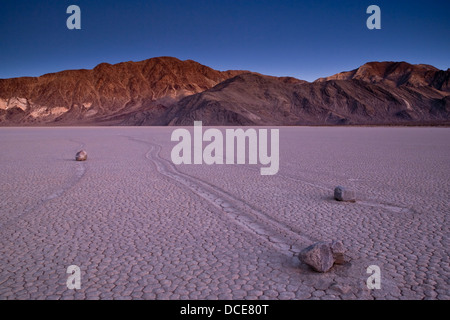 Tracks left by mysterious moving rocks on the dried flat mud at the Racetrack Playa, Death Valley National Park, California Stock Photo