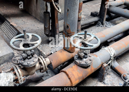 Pipes and valves in an abandoned factory Stock Photo