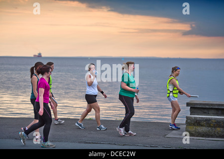 A womens fitness group training in the evening at Portishead, North Somerset UK Stock Photo