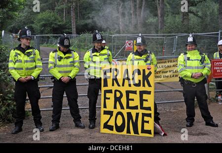 Balcombe Sussex UK 16 August 2013 - Police at the entrance of the Cuadrilla  site where anti Fracking protesters gather in the West Sussex village of Balcombe where the company are carrying out exploration drilling . Thousands of protesters are expected to join the protest over the forthcoming weekend