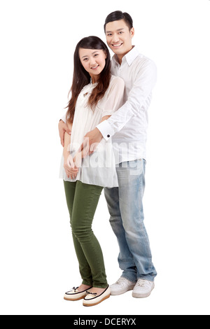 studio portrait of young asian couple, standing back to back, looking ...