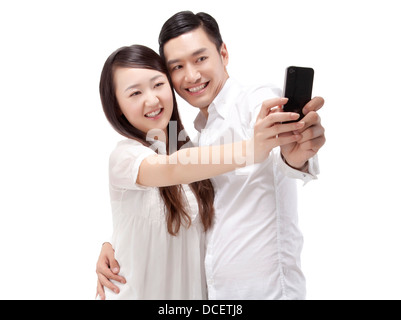 Oriental fashion young couple using mobile phone self-timer Stock Photo